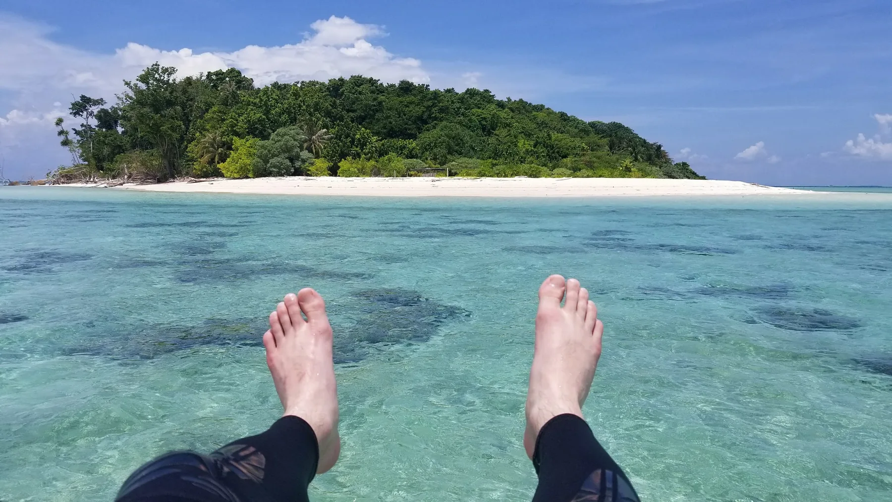 Clear turquoise water and a white-sand island off the coast of Malaysia
